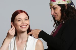 makeup artist adjusting model